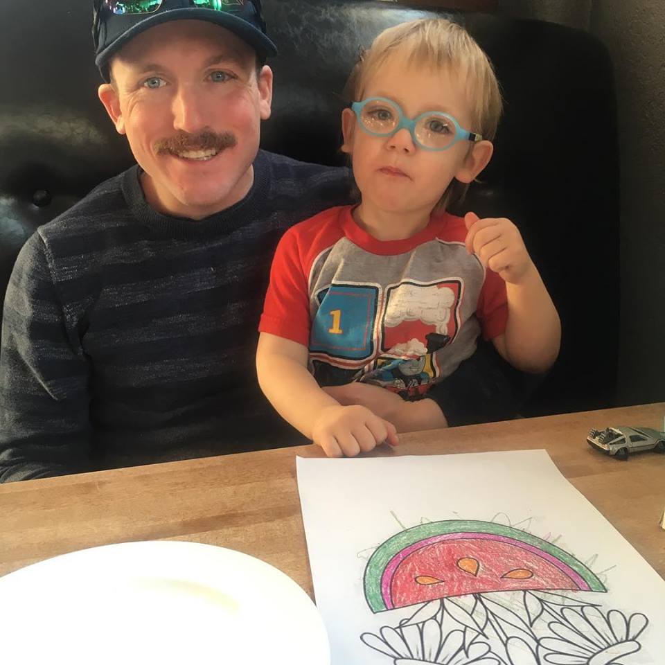 a young boy sitting at a table