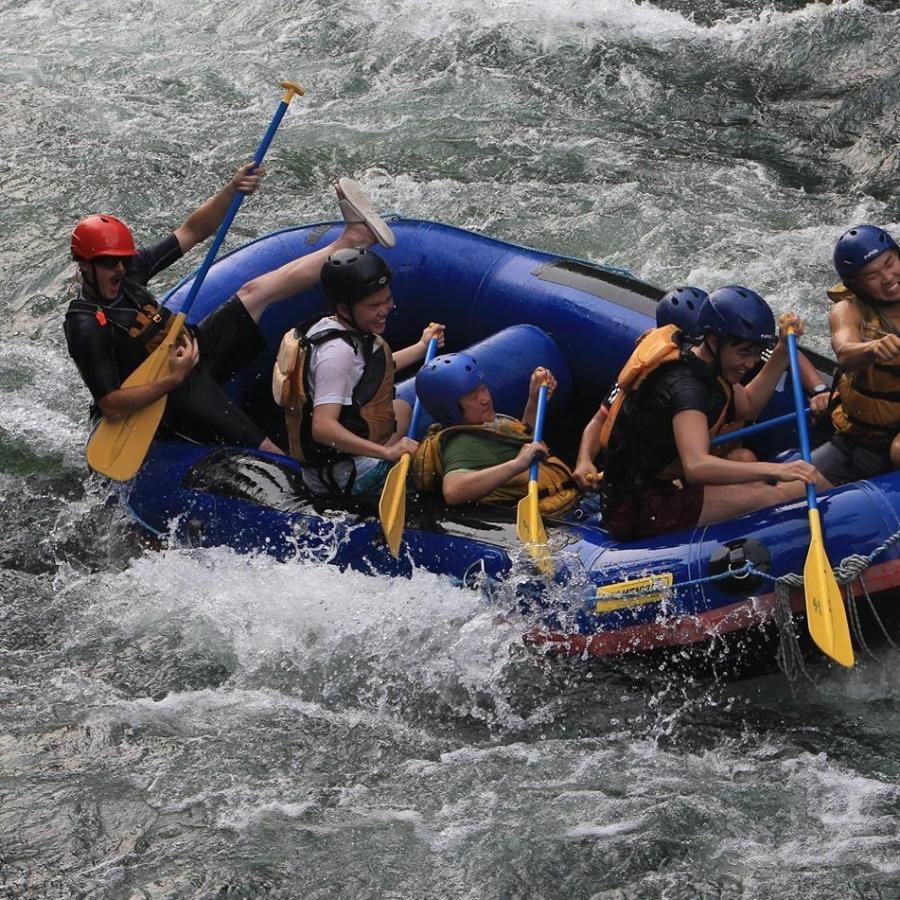a group of people on a raft in the water