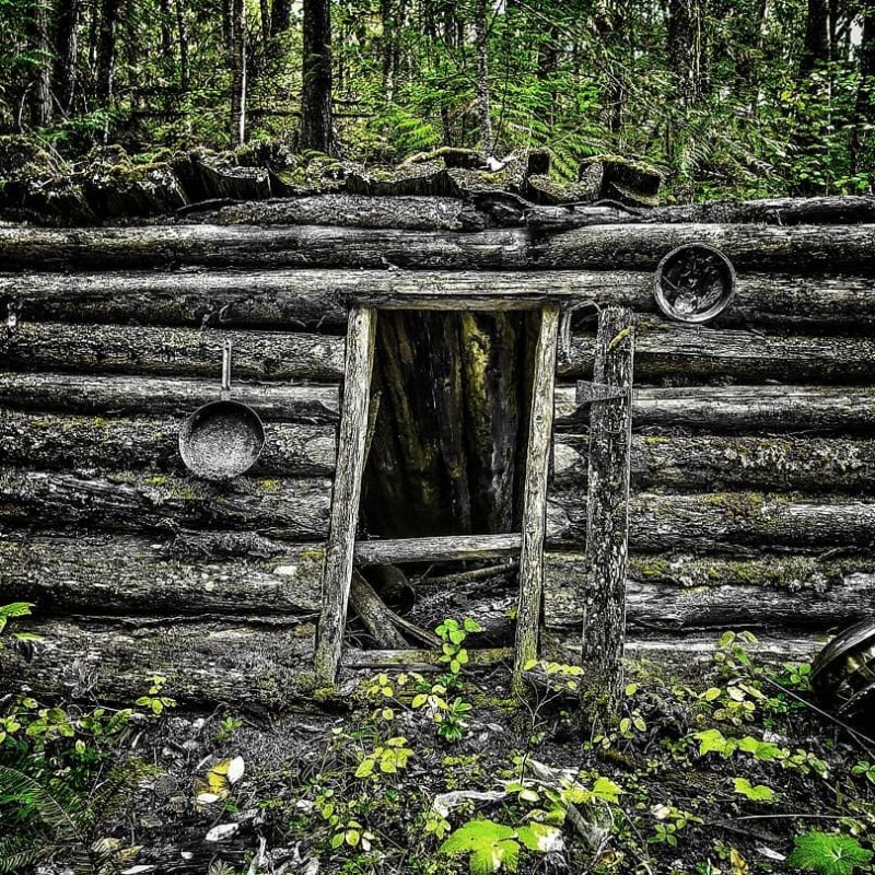 a green bench sitting on top of a wooden fence