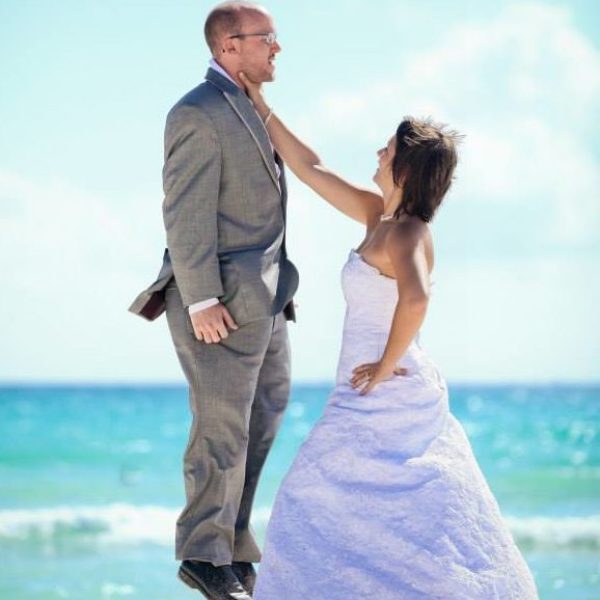 a man and a woman standing on a beach