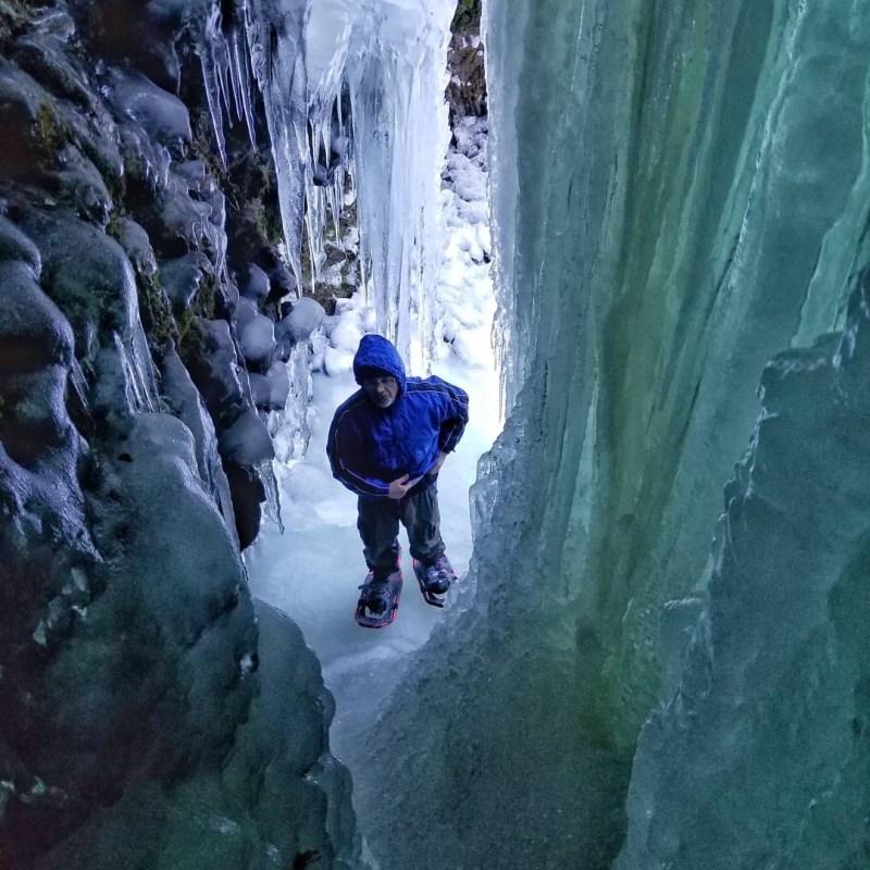 a man riding skis down a snow covered slope