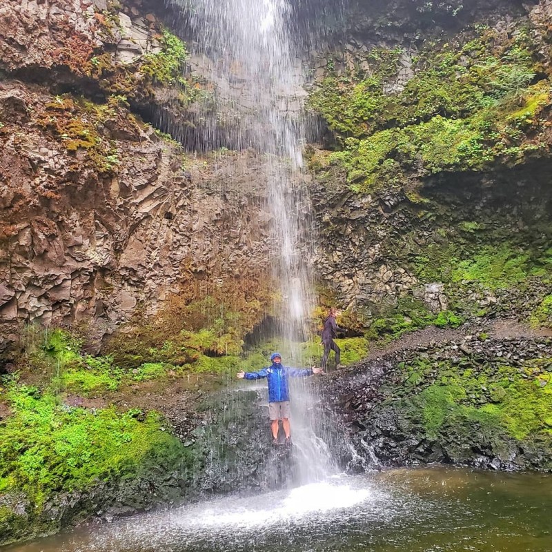 a waterfall going over a body of water