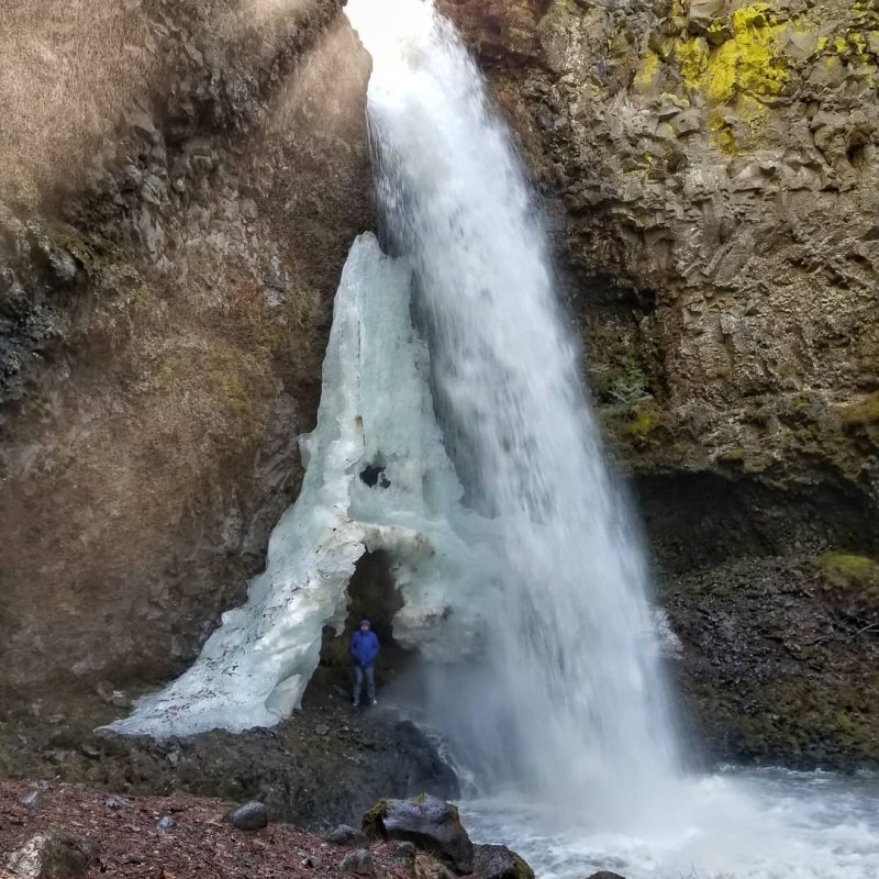 a large waterfall over some water
