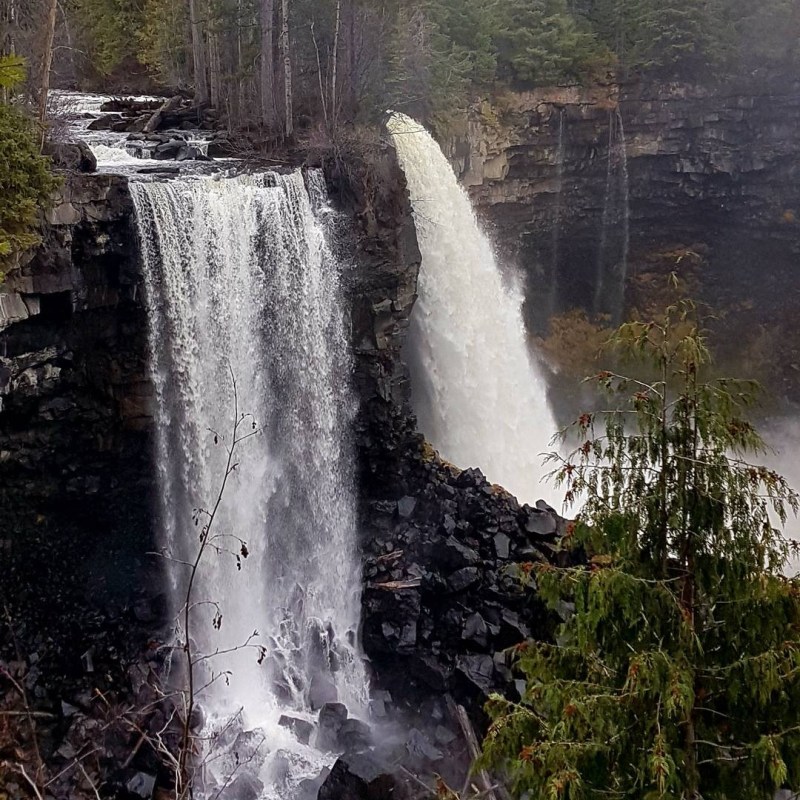 a large waterfall over some water