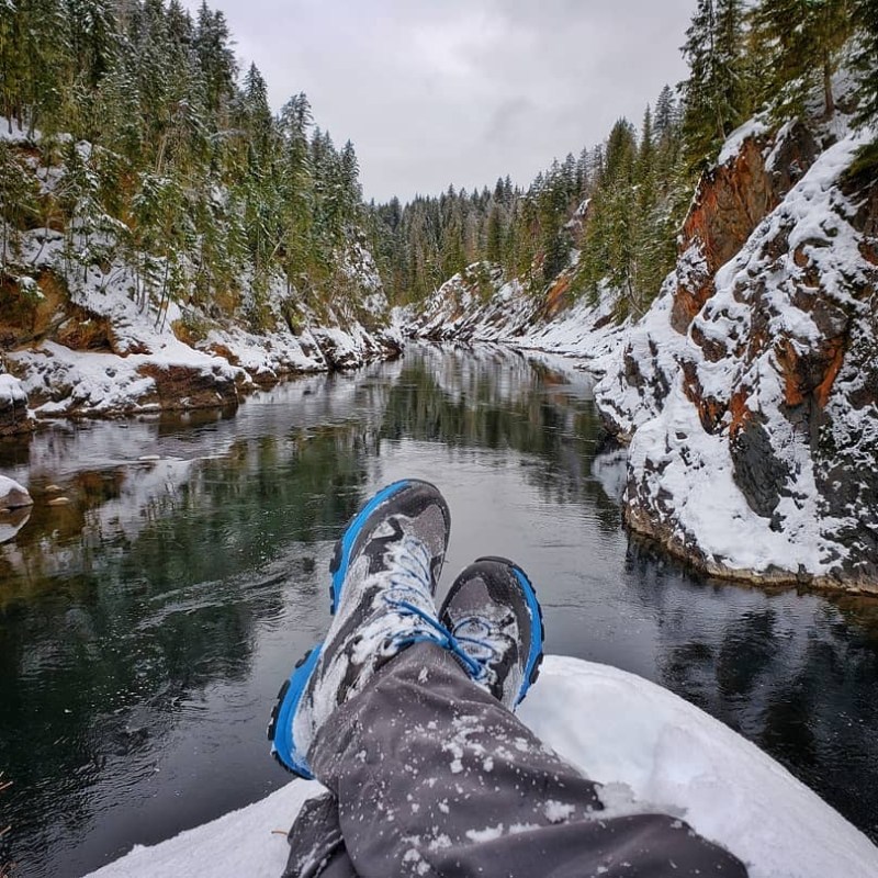 a man riding a snowboard down a snow covered slope