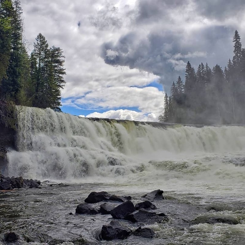 a waterfall with trees in the background