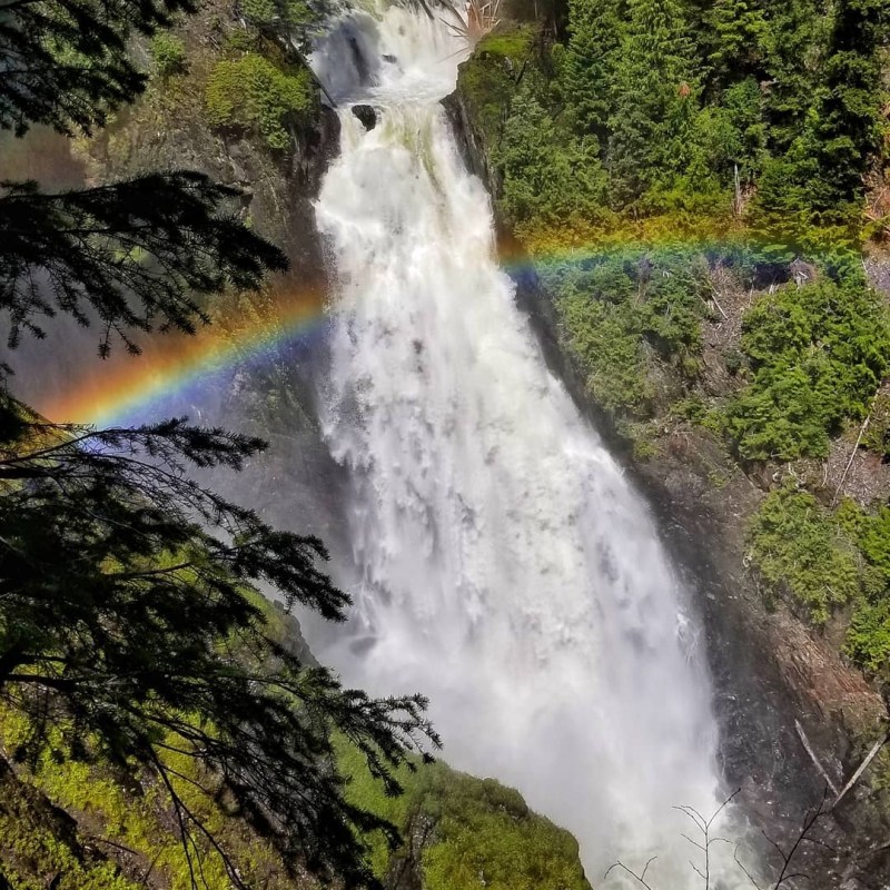a large waterfall over some water