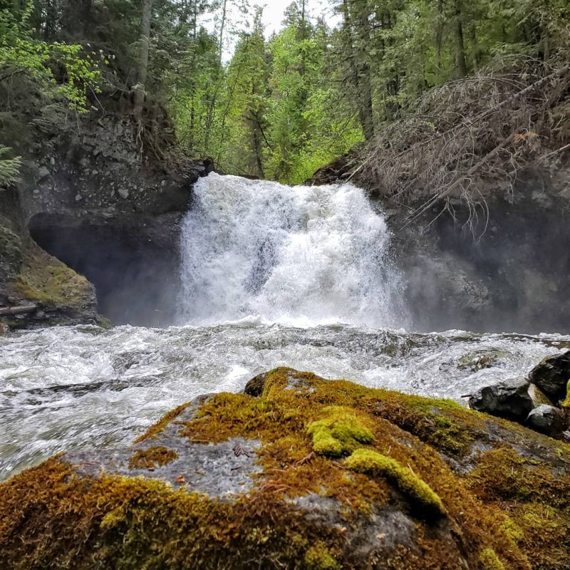 a large waterfall over some water