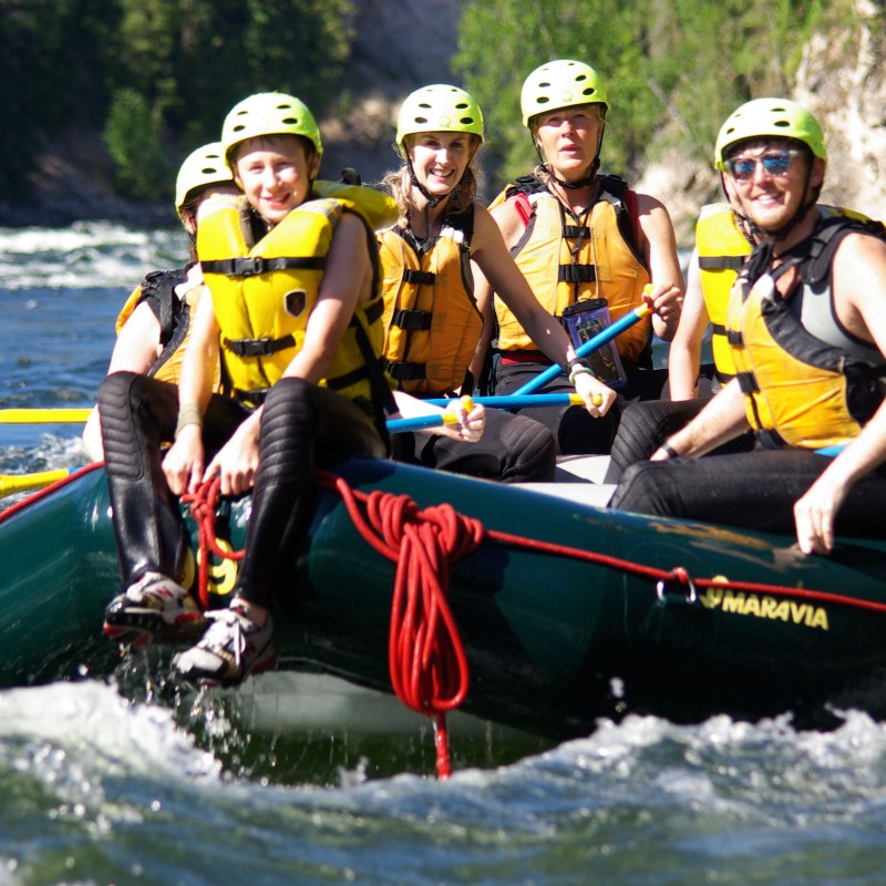 a group of people riding on the back of a boat