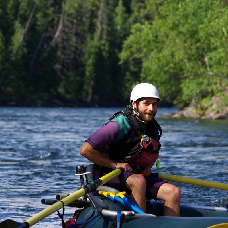a man rowing a boat in a body of water