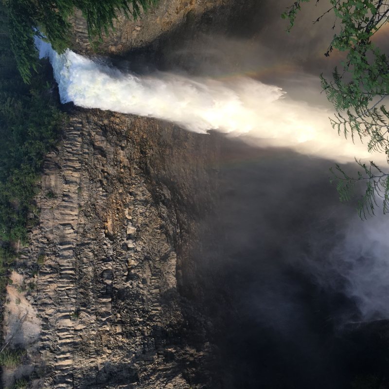 a waterfall with smoke coming out of it