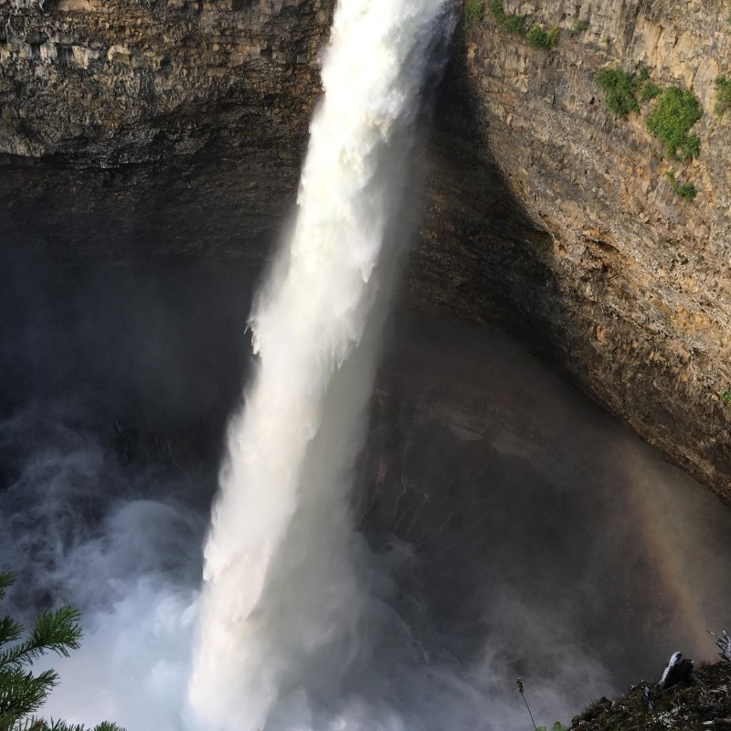 a waterfall with smoke coming out of it