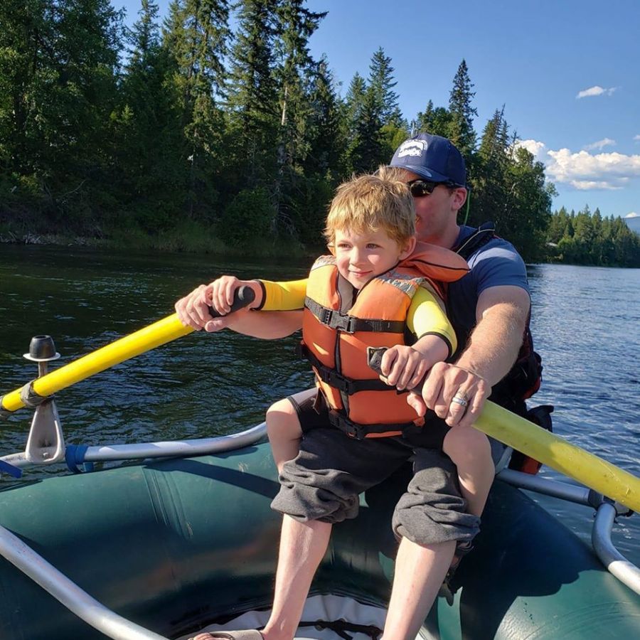 a boy swinging a baseball bat on a boat