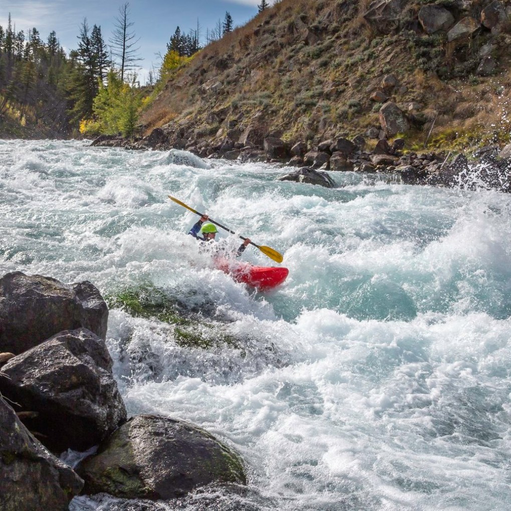 a man riding a wave on top of a rock