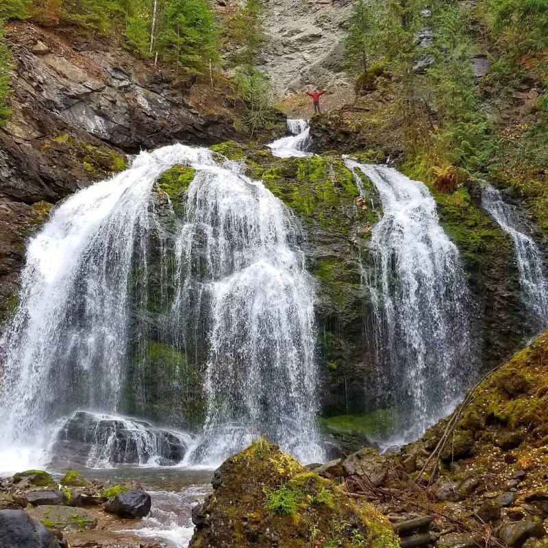a large waterfall over some water