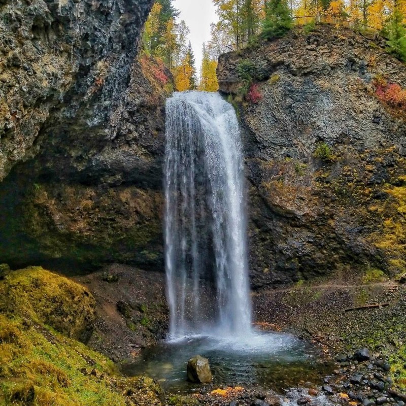 a large waterfall over some water