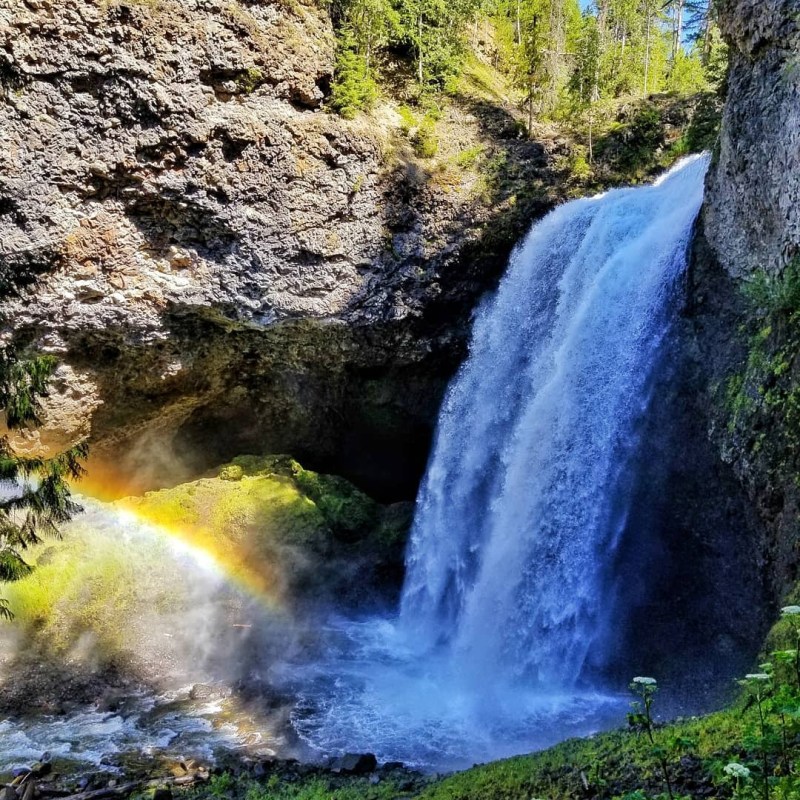 a large waterfall over some water