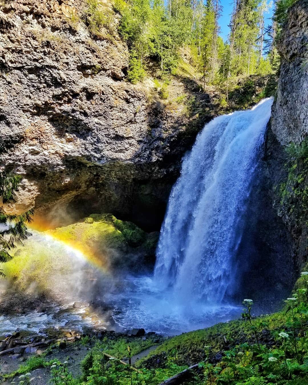 a large waterfall over some water