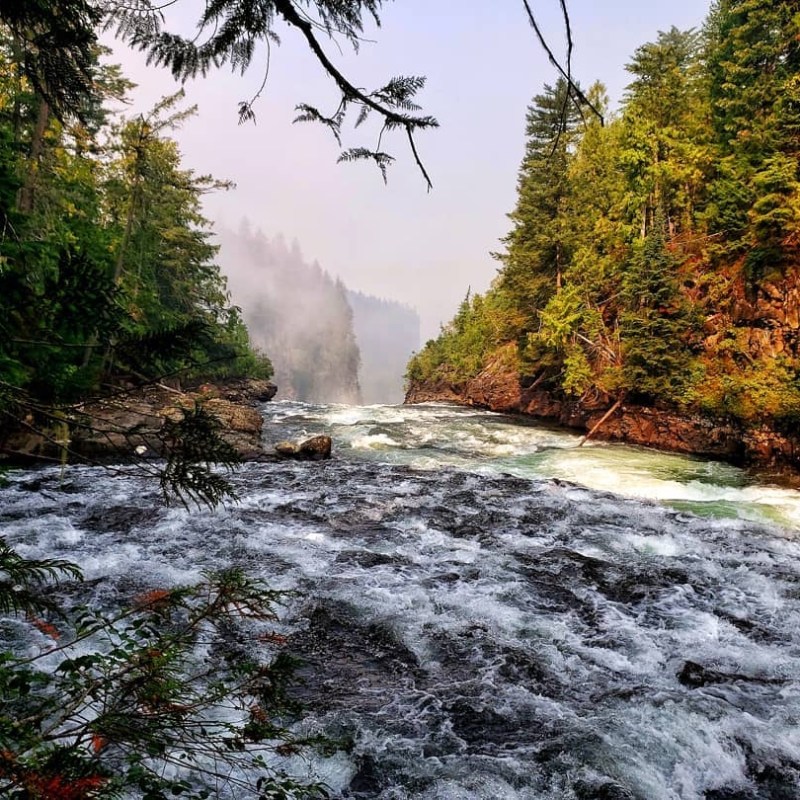 a large waterfall over a body of water