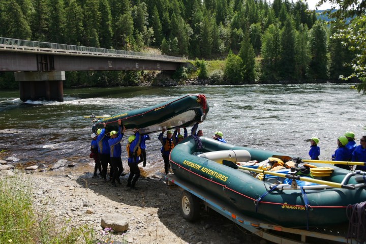 a group of people in a boat on a river