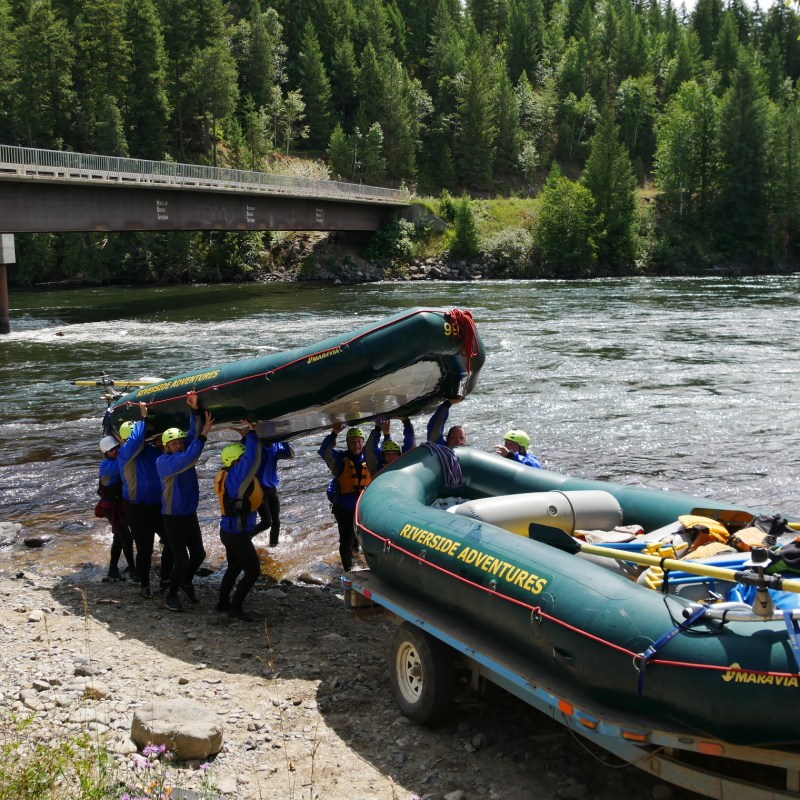 a group of people in a boat on a river