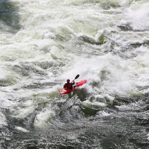 a man riding a wave on top of a body of water