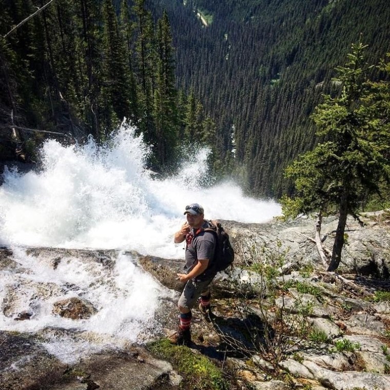 a man riding a wave on top of a mountain