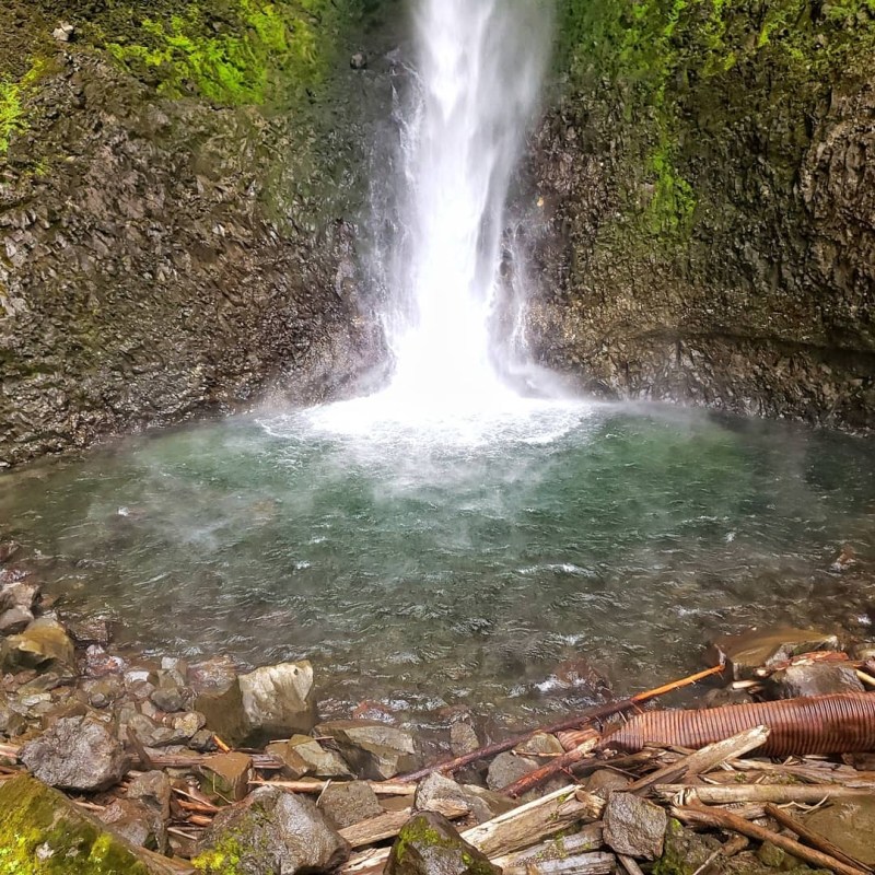 a large waterfall over a body of water