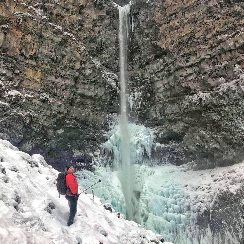 a person riding skis down a snow covered mountain