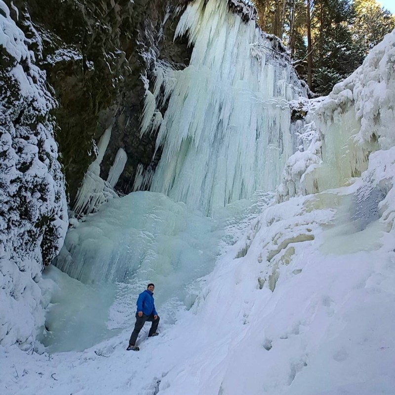a group of people riding skis down a snow covered slope