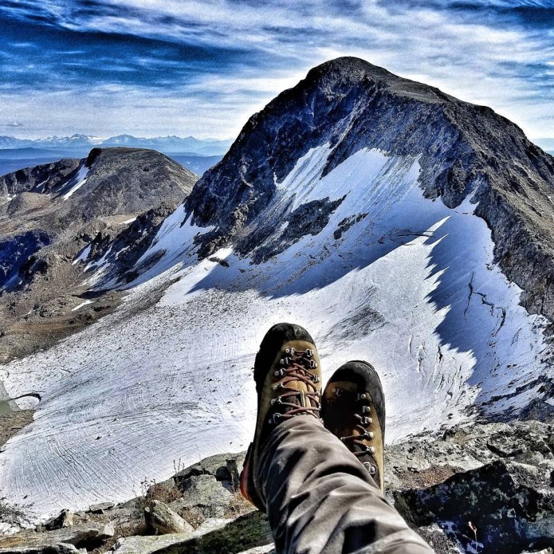 a man standing on top of a snow covered mountain