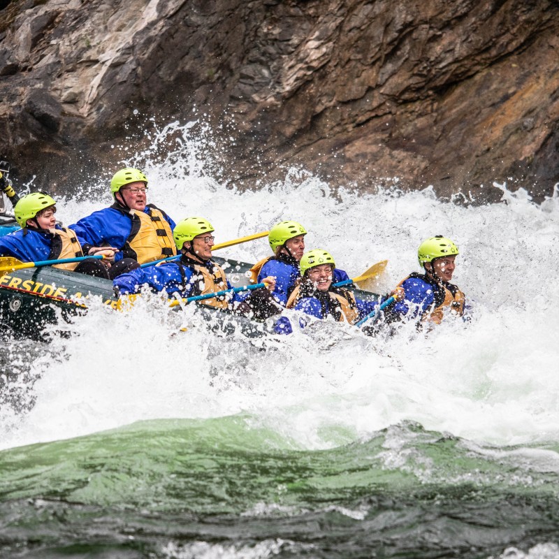 a group of people riding skis on a raft in the water