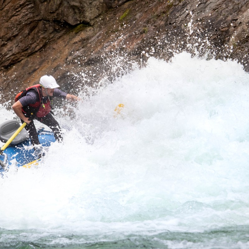 a man riding a wave on top of a hill