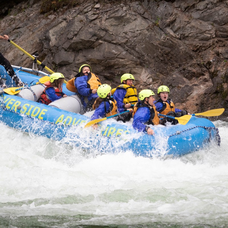 a group of people riding skis on a raft
