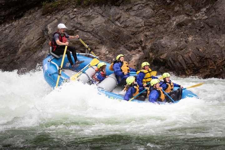 a group of people riding skis on a raft