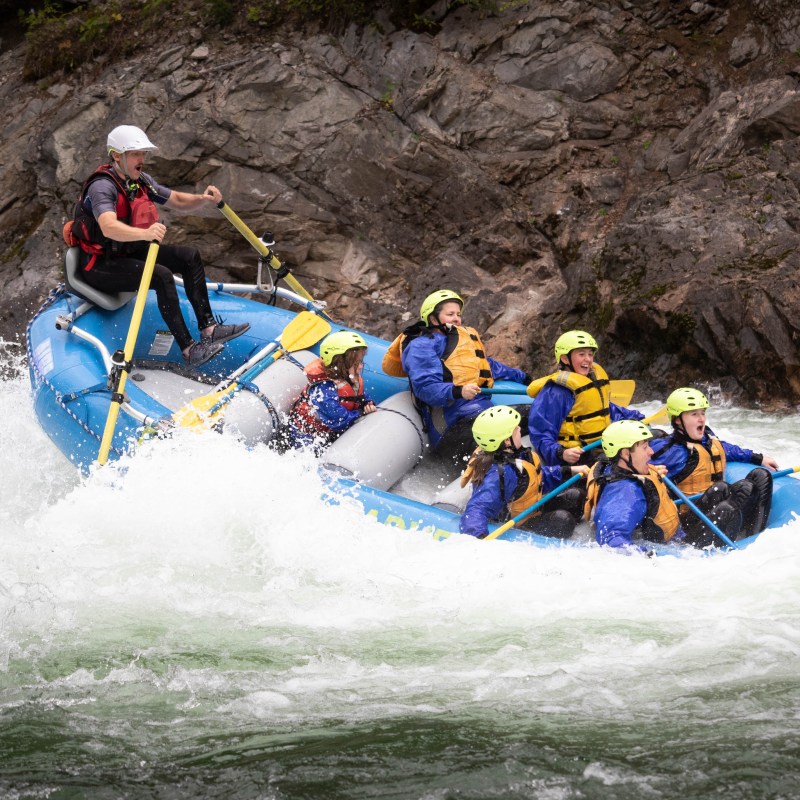 a group of people riding skis on a raft