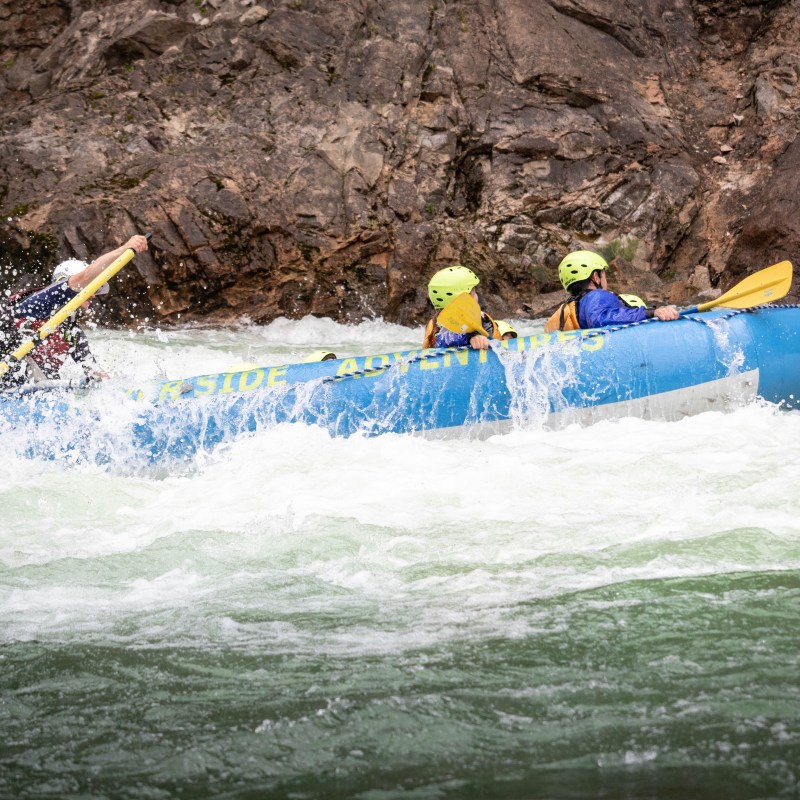a group of people riding skis on a raft in the water
