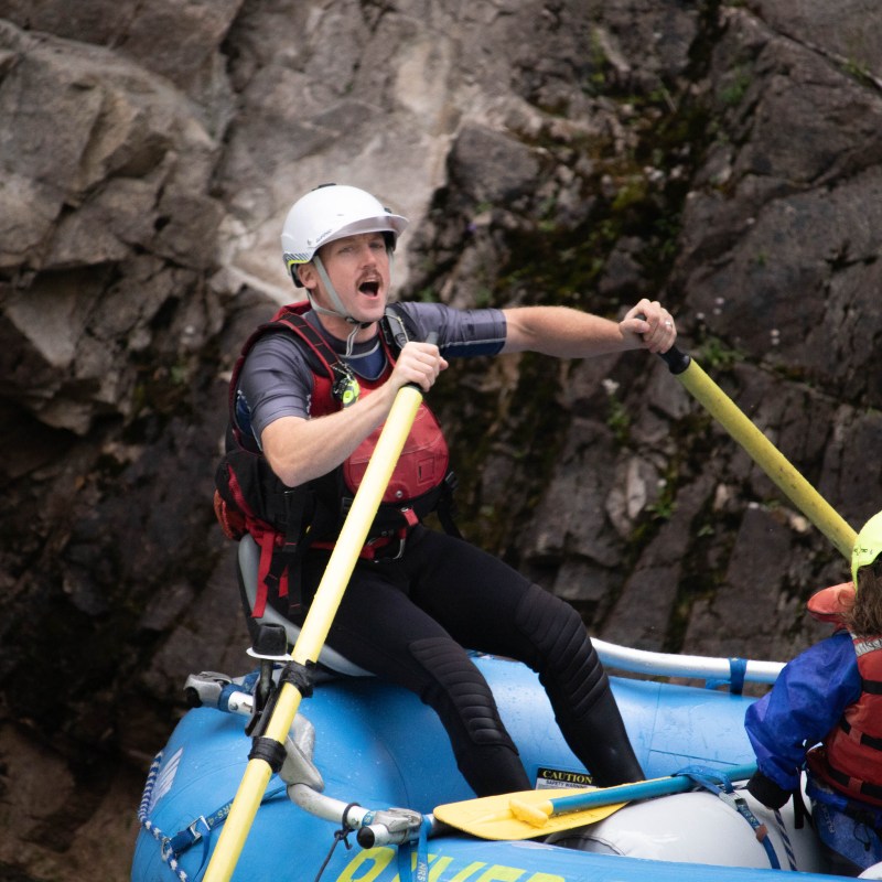 a person with a helmet on a rock