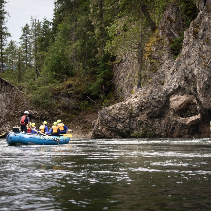 a group of people in a small boat in a body of water