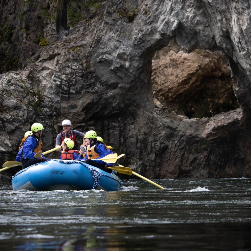 a man riding water skis on top of a rock