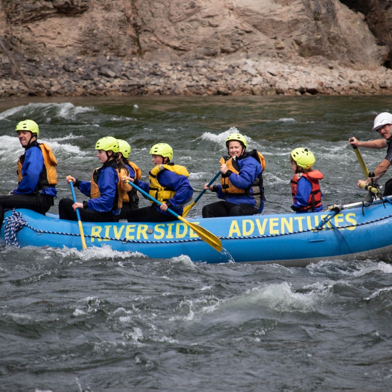 a group of people on a raft in a body of water