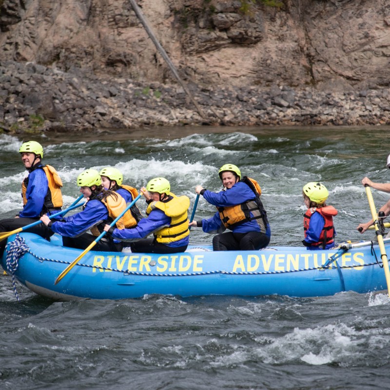 a group of people riding on a raft in a body of water