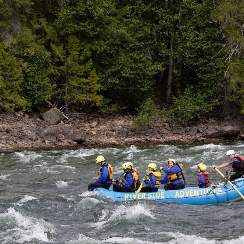 a group of people on a raft in a body of water