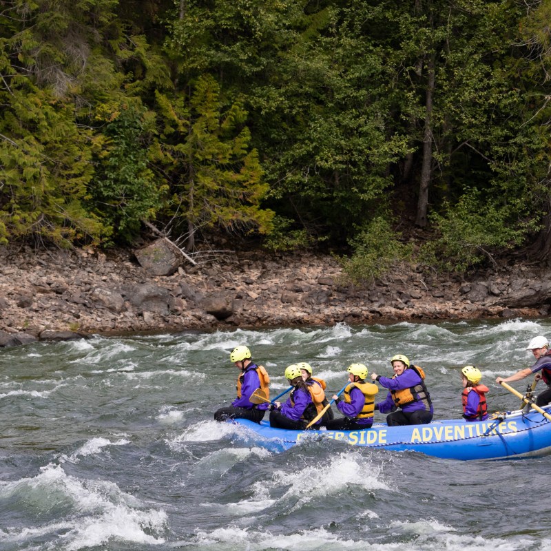 a group of people on a raft in a body of water
