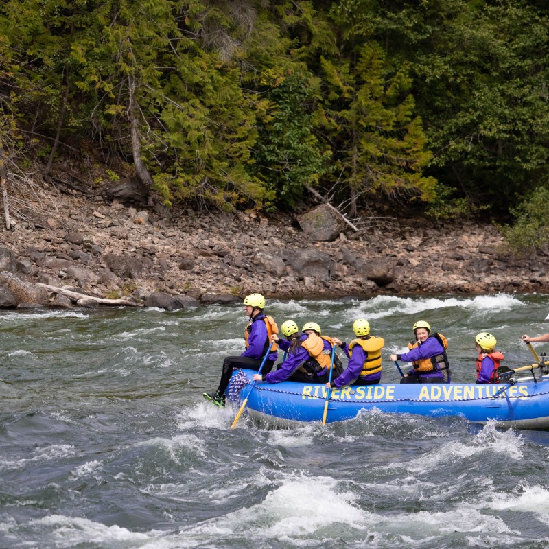 a group of people riding on the back of a boat