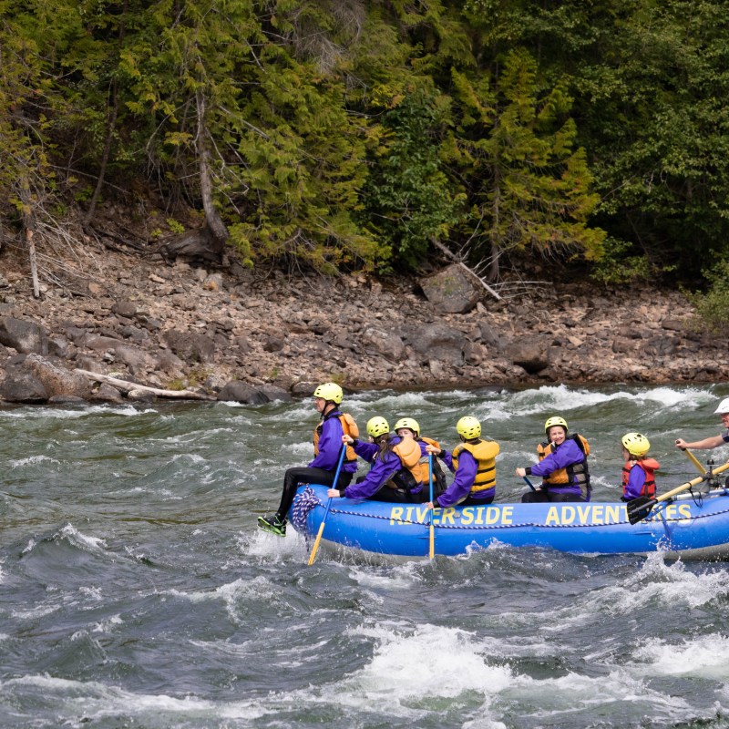 a group of people on a raft in a body of water