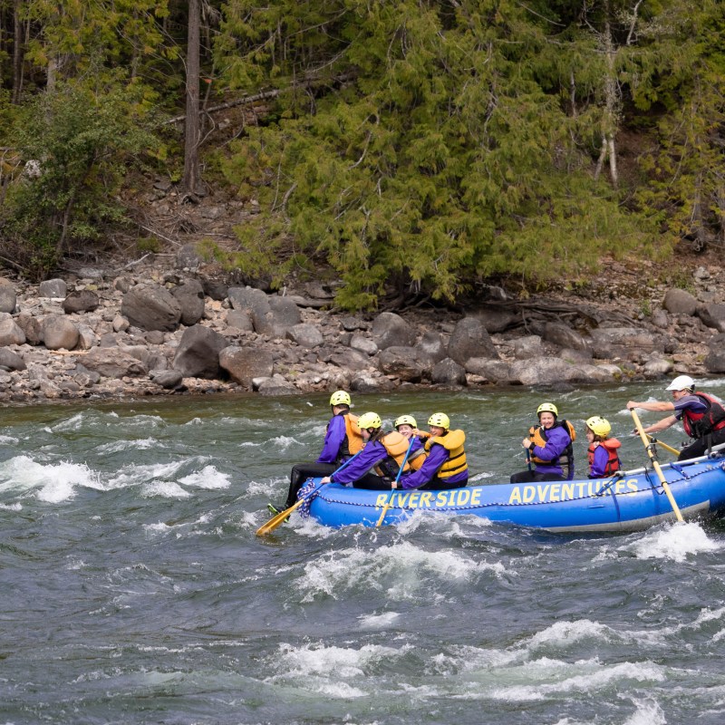 a group of people on a raft in a body of water
