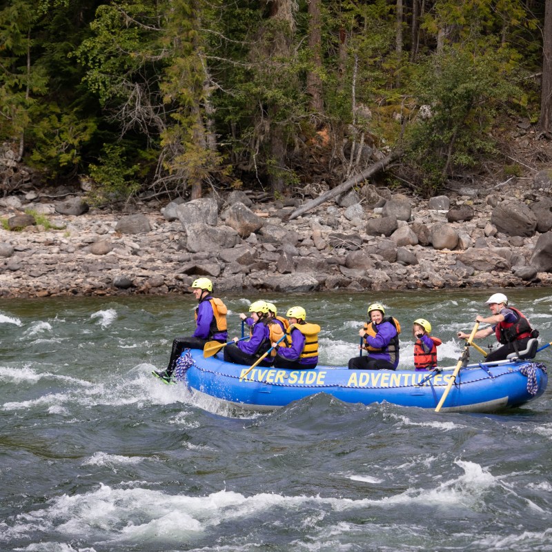 a group of people riding on a raft in a body of water
