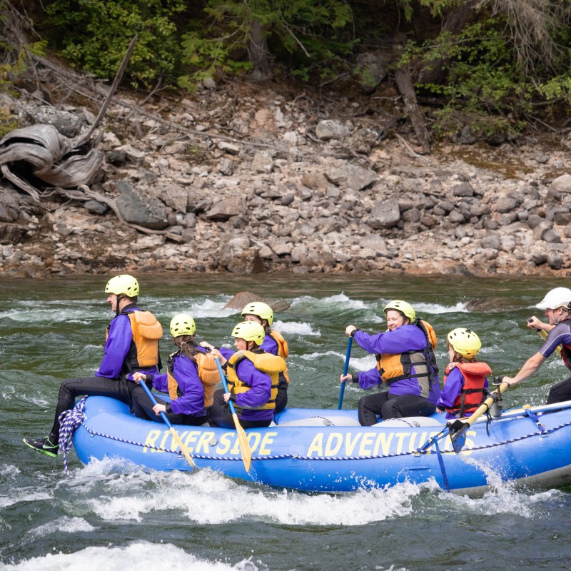 a group of people riding on a raft in a body of water
