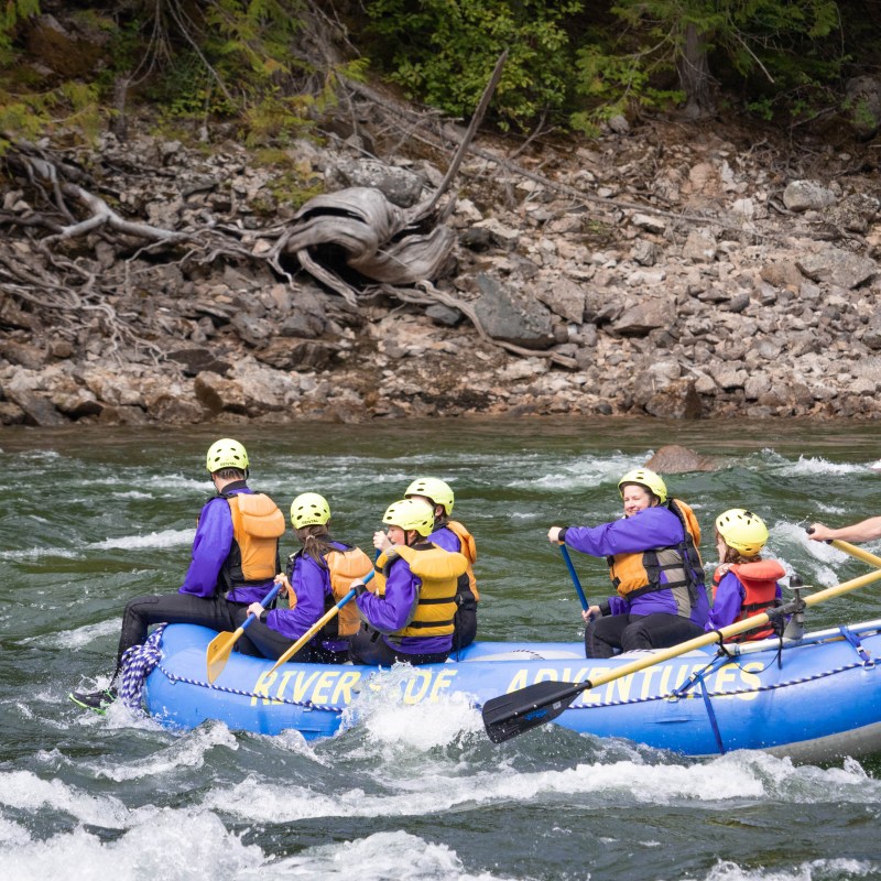 a group of people riding on a raft in a body of water